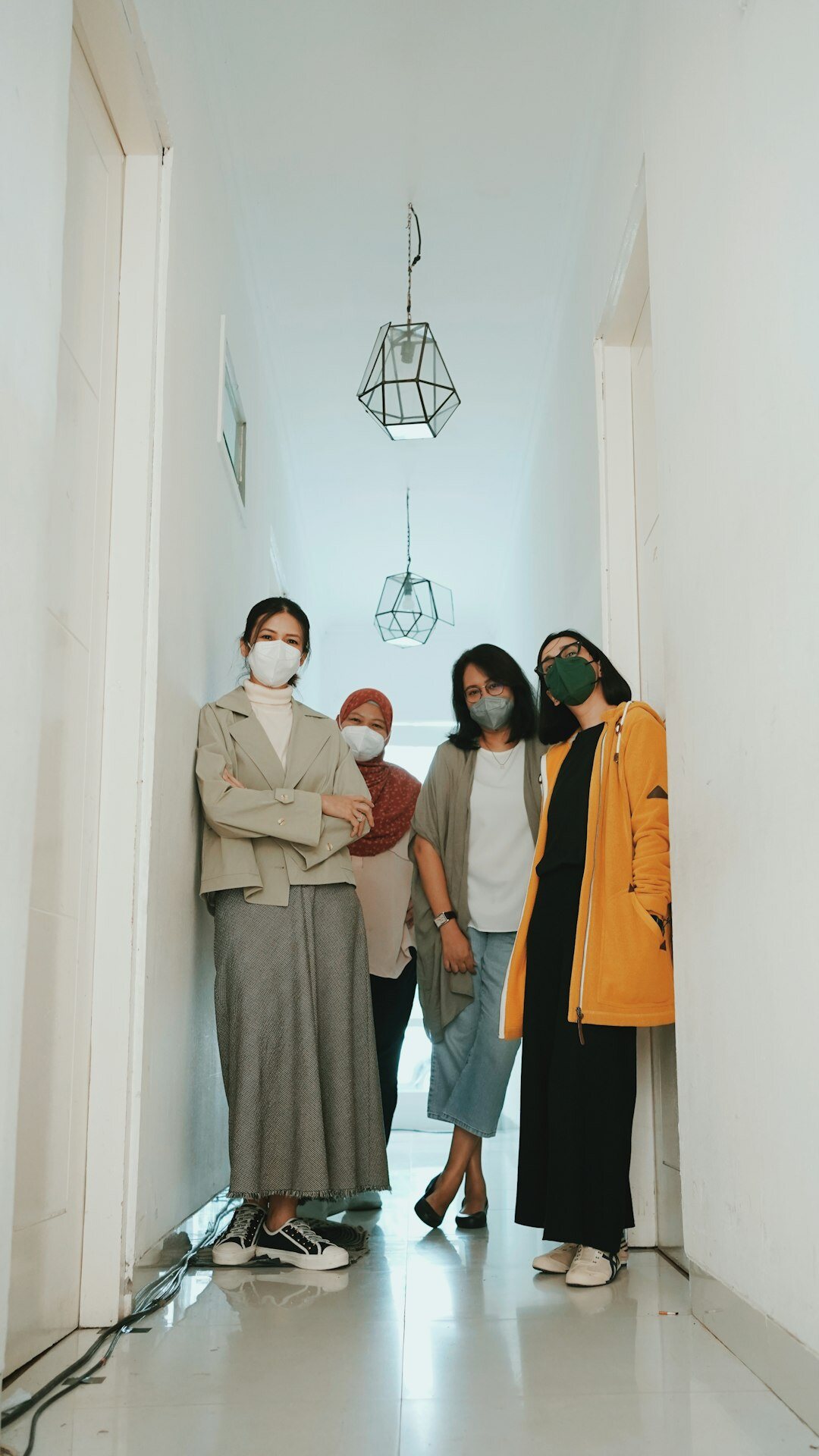 Group photo of a diverse team of professionals standing together indoors